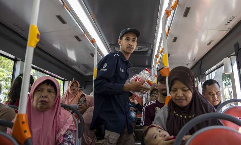An hour-long bus ride with unlimited stops costs three large bottles, five medium bottles or 10 plastic cups in an Indonesian re